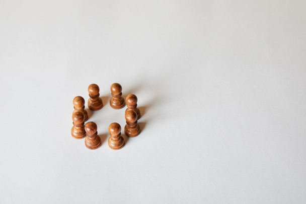 wooden pawn pieces of chess on grey background - Zdjęcie, obraz