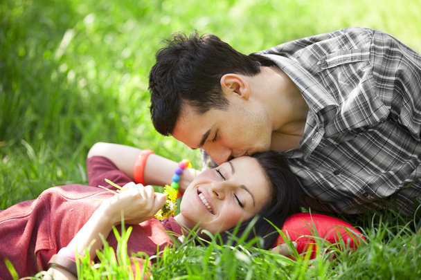 Couple Relaxing on Green grass - Фото, изображение