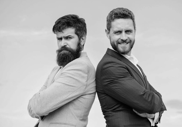 Bearded business people posing confidently. Perfect in every detail. Business men stand blue sky background. Well groomed appearance improves business reputation entrepreneur. Business people concept - Photo, Image