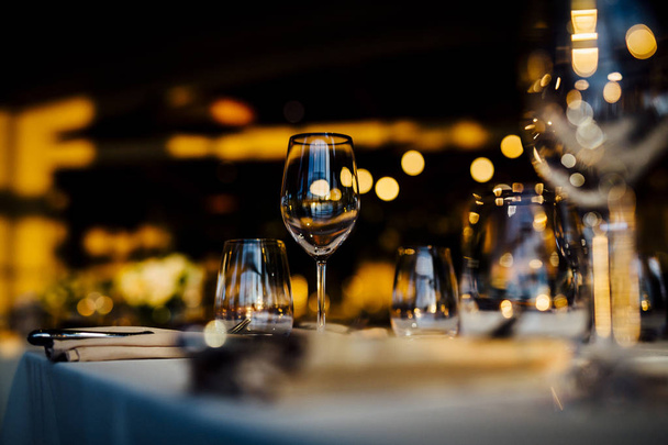 Luxury table settings for fine dining with and glassware, beautiful blurred  background. For events, weddings.  Preparation for holiday  passover, Christmas and Hanukkah dinner night. props for weddings, birthdays, and celebrations. - 写真・画像