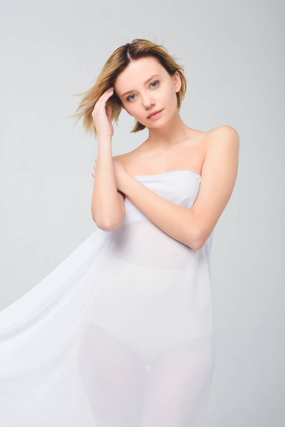 elegant attractive girl posing in white cloth, isolated on grey - Valokuva, kuva