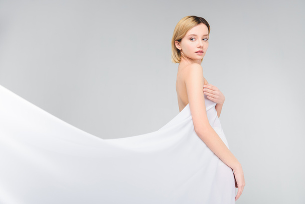 elegant naked girl posing in white veil, isolated on grey - 写真・画像