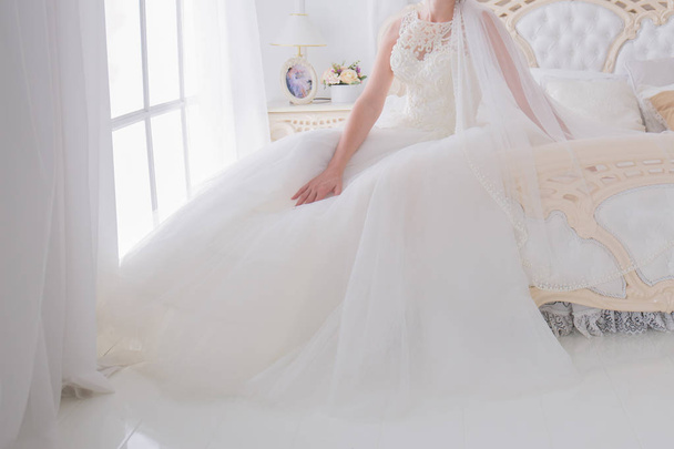 bride in a wedding dress in a bright room - Photo, image