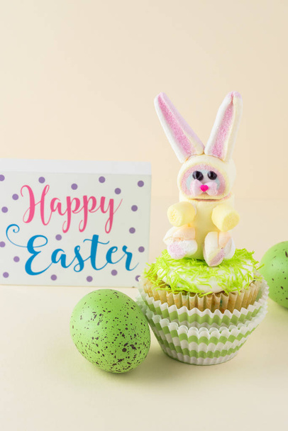 Cupcake decorated with rainbow marshmallow bunny for Easter. - 写真・画像