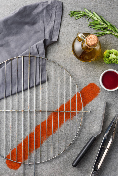 top view of metal grille with oil, broccoli, cloth and sauce - Photo, Image