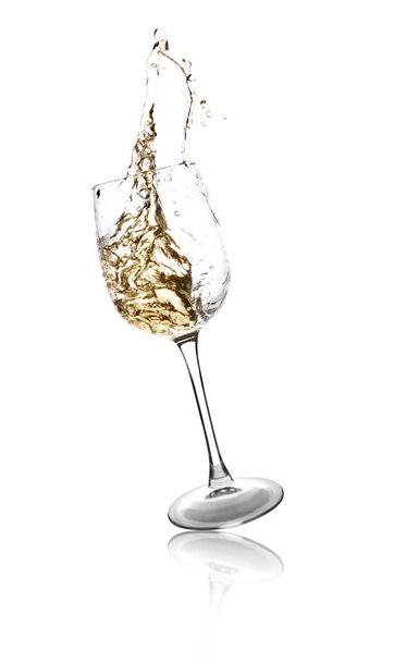 Glass of splashing wine on white background - Foto, Imagem