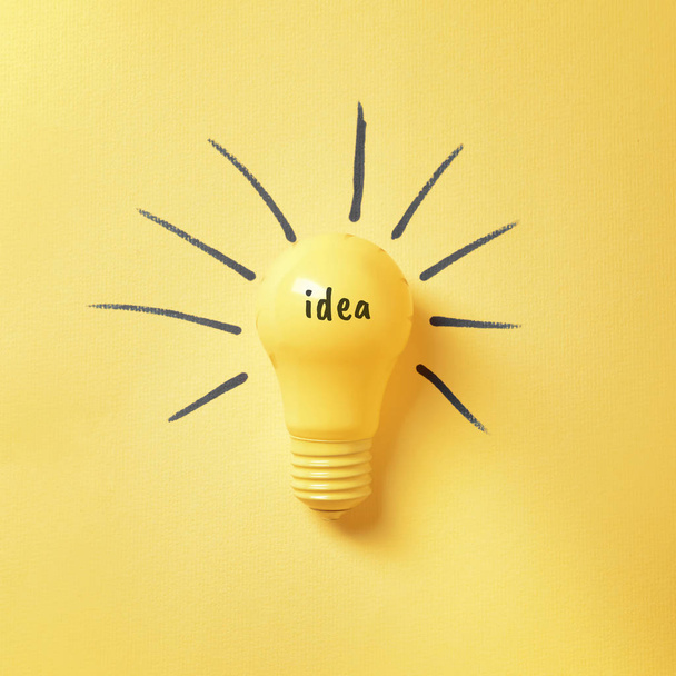 Light bulb as symbol of new idea on color background - Foto, Imagen