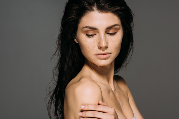beautiful brunette naked girl posing isolated on grey - Photo, Image