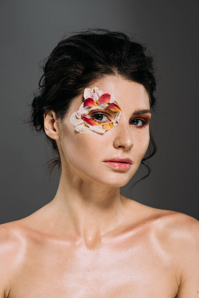 beautiful young woman with floral petals around eye isolated on grey - Fotoğraf, Görsel