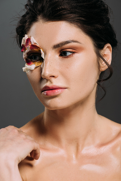 attractive young woman with floral petals around eye isolated on grey - Fotoğraf, Görsel