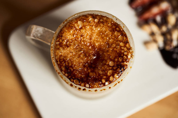 Macro photo of hot latte with baked caramel crust. Food concept. Top view close up image of coffee. - Φωτογραφία, εικόνα