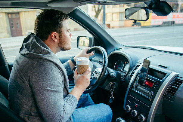 angry man driving car and drinking coffee. traffic collapse. lifestyle - Photo, Image