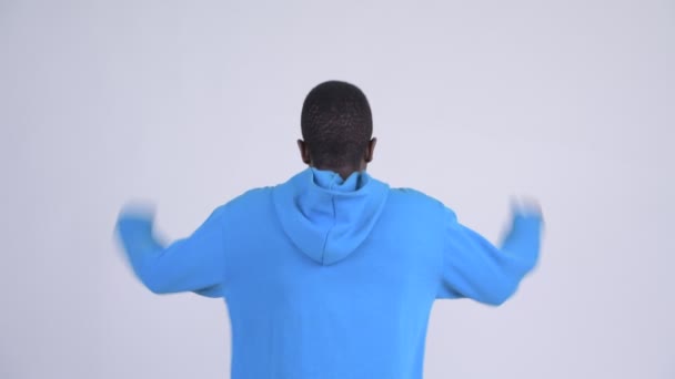 Rear view of young happy African man with fists raised - Imágenes, Vídeo