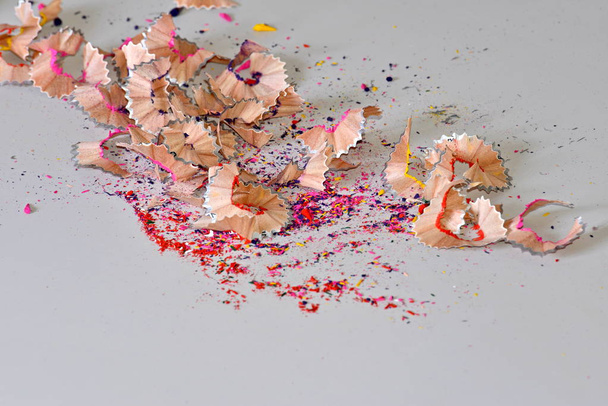 A scrap of colored pencils is laid out on a white background. Creative idea for the background texture. - Photo, Image