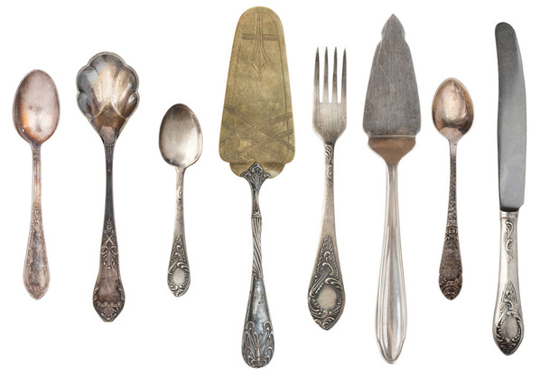 Vintage Antique silverware isolated on white background. Retro spoons, forks, knives, shovels for cake. - Photo, Image