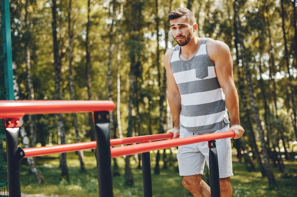 Sports man in a morning summer park  - Photo, image