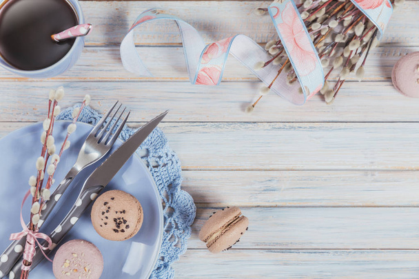 Easter table setting with coffee, macaroon cookies, willow branches and cutlery. Spring holiday concept - Fotoğraf, Görsel