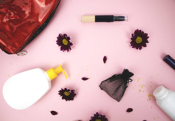 Kosmetika na stole na ženu. Kosmetické tašky, kosmetické a hygienické výrobky. Růžový pozadí pro text - Fotografie, Obrázek