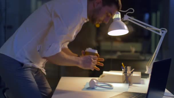 businessman with laptop and headphones at night - Felvétel, videó