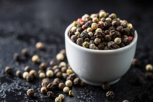 Different types of dried peppercorn in bowl. - 写真・画像