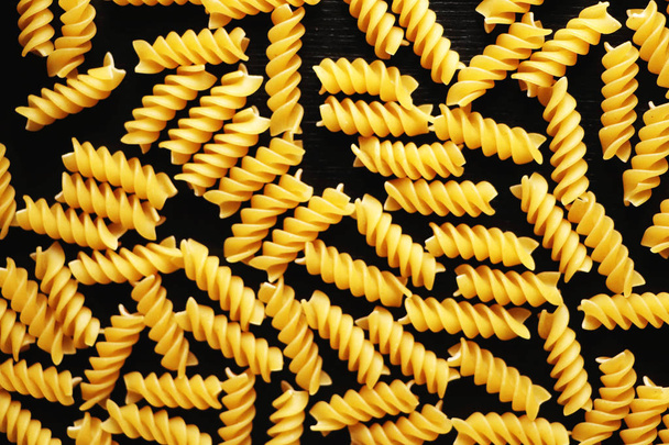 Pasta on a black background. Texture - Photo, Image