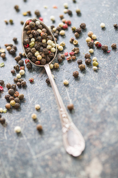 Different types of dried peppercorn in spoon. - Foto, imagen