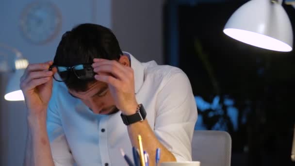 stressed businessman taking glasses off at office - Video