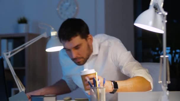 businessman with blueprint and laptop at night - Metraje, vídeo