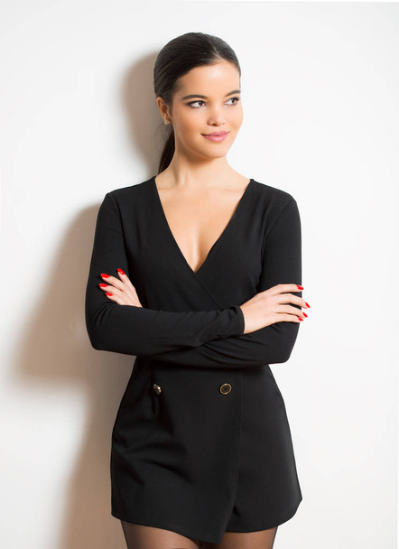 Elegant smiling young woman in black dress. - Фото, зображення