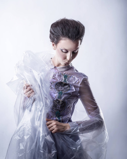 beautiful young woman in fashionable dress and transparent Cape - Foto, Bild