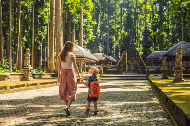 Mom and son travelers discovering Ubud forest in Monkey forest, Bali Indonesia. Traveling with children concept. - Foto, imagen