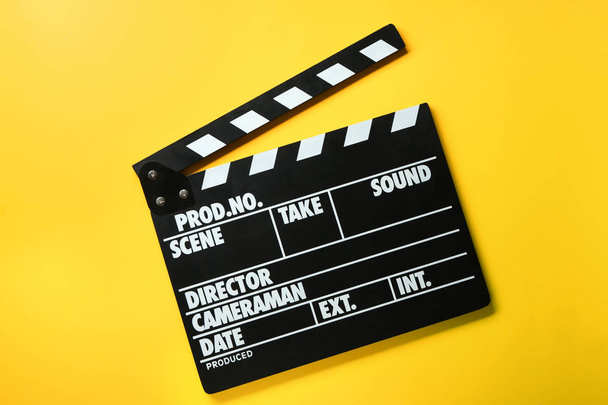 Cinema clapperboard on color background - Фото, зображення