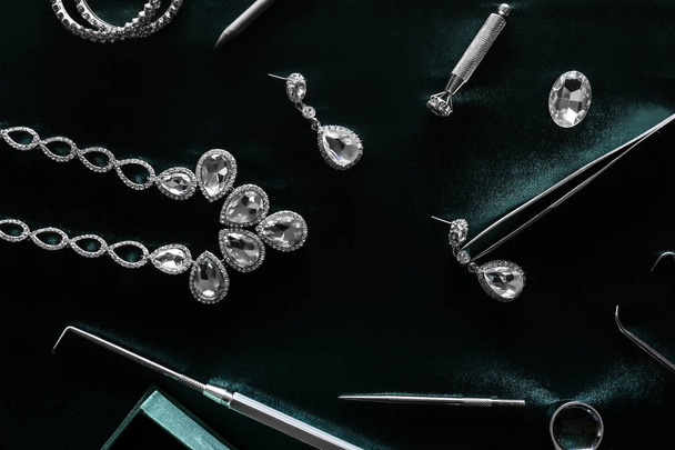 Jeweller's tools and beautiful adornments on table - Zdjęcie, obraz