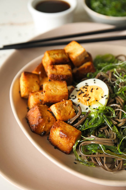 Tasty fried tofu cheese with soba noodles on plate, closeup - Photo, Image