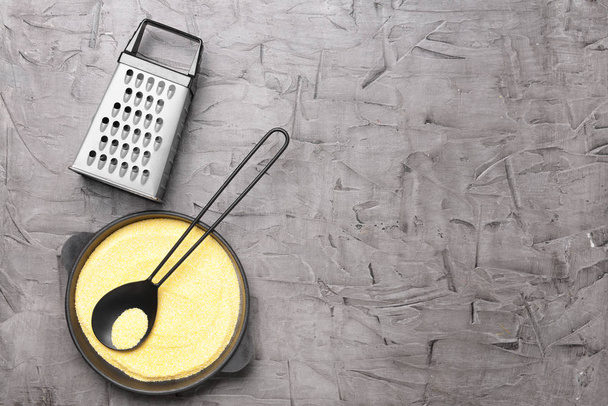 Kitchen utensils with grains on grey table - Foto, Imagen