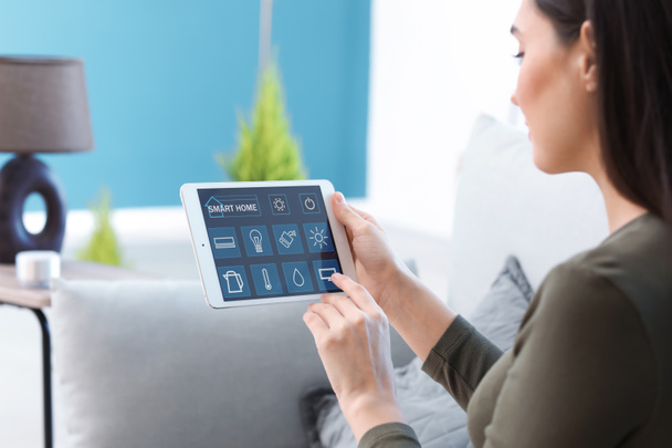 Young woman using application of smart home automation - Photo, Image