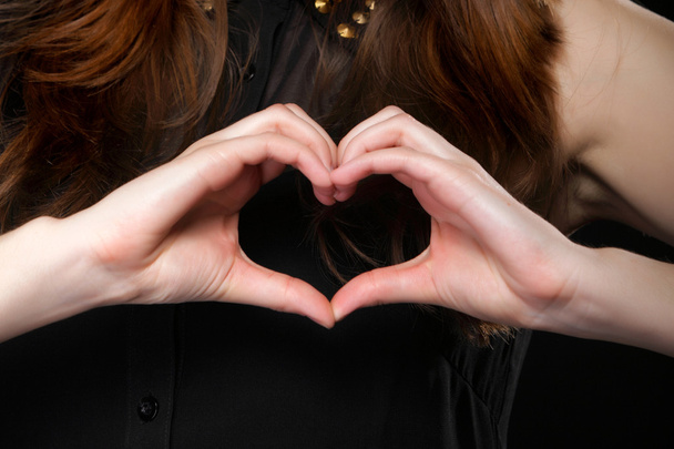 κορίτσι κάνει καρδιά σχήμα σύμβολο αγάπη με τα χέρια της. - Φωτογραφία, εικόνα