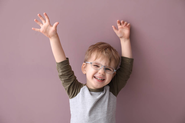 Portrait of funny little boy on color background - Photo, Image
