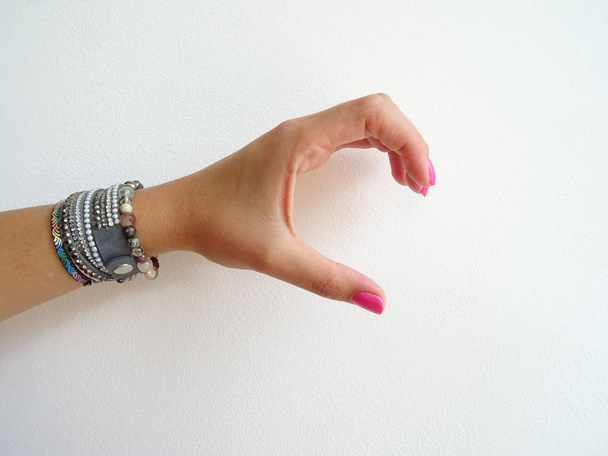 Female Hand with Modern Pink Art Nail Polish and Bracelets showi - Φωτογραφία, εικόνα