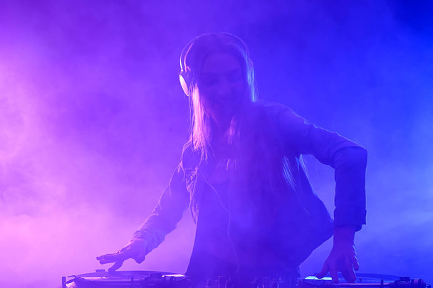 Female DJ playing music in club - Фото, изображение