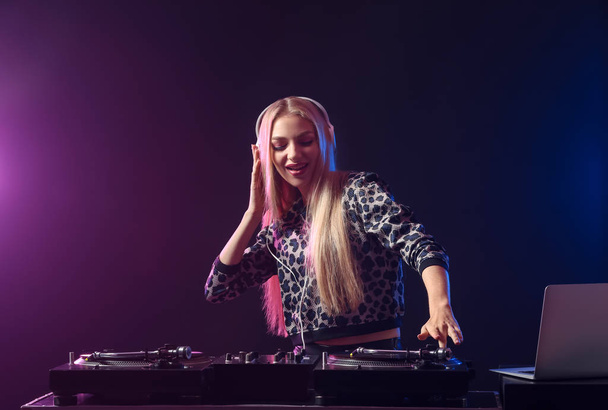 Female DJ playing music in club - 写真・画像