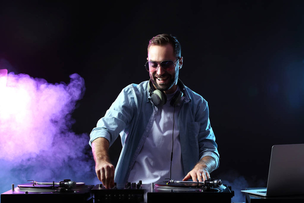 Male DJ playing music in club - Photo, image