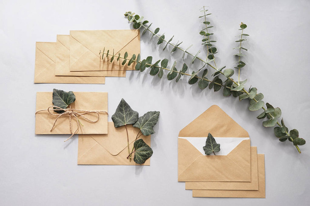 Paper envelopes with floral decor on light background - 写真・画像