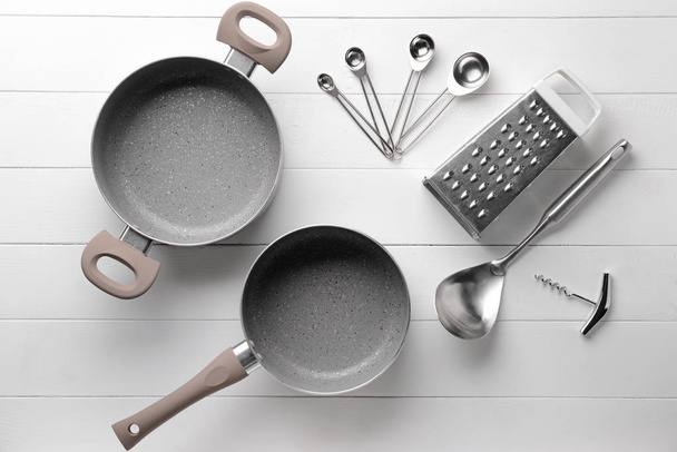Set of kitchen utensils on white wooden background - Photo, Image