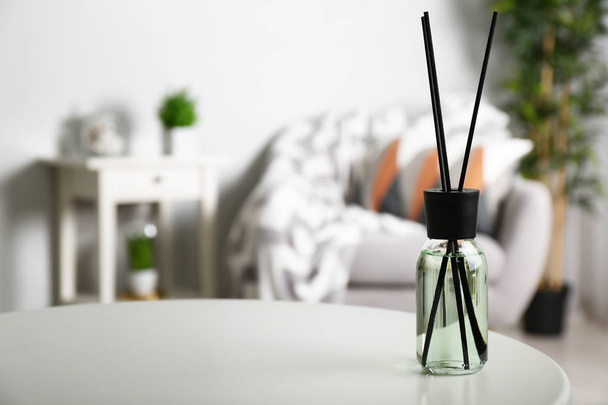 Reed diffuser on table in room - Photo, image