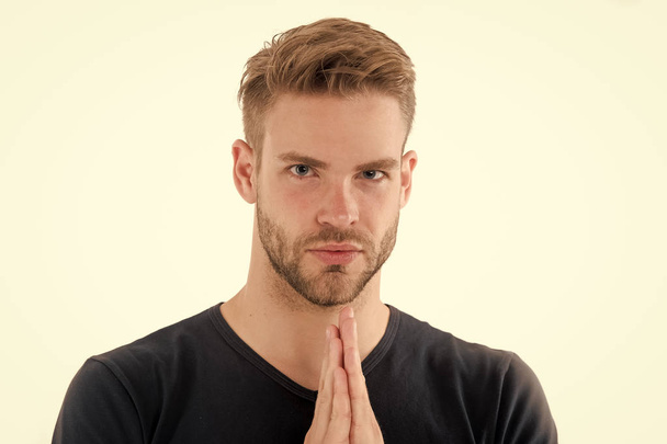 Bearded man pray isolated on white. Guy prayer hold hands clasped near unshaven face. Full concentration. Praying for something. Calm and handsome - Фото, изображение