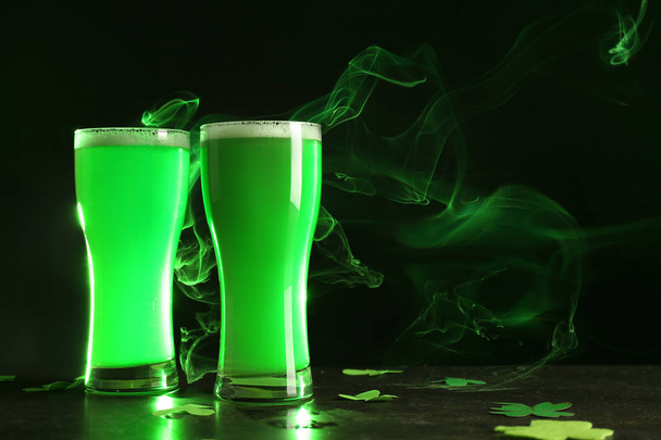 Glasses of green beer on table. Saint Patrick's Day celebration - Photo, Image