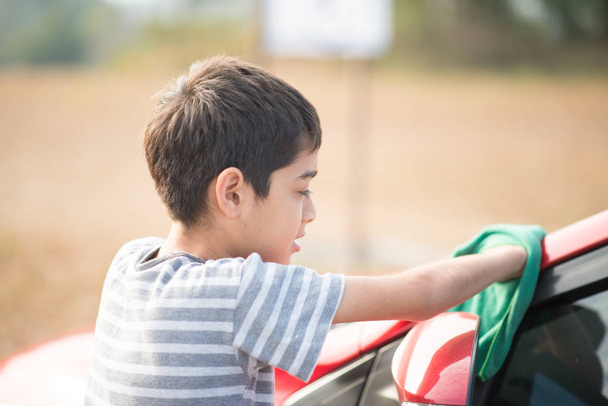 Little boy cleaning car - Фото, изображение