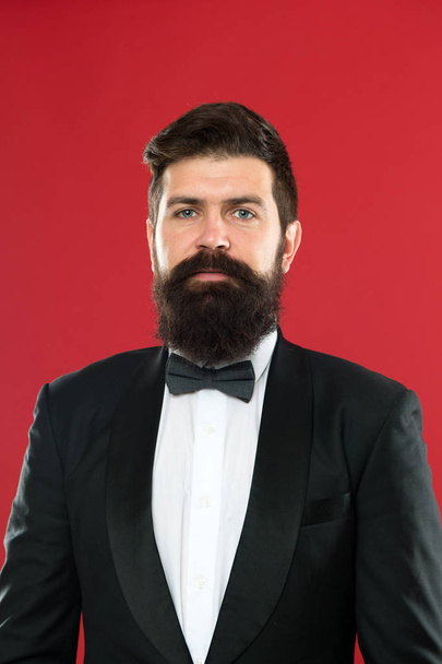 Wedding mens suit. Formal wear male fashion. Businessman in tuxedo. Formal event. Man groom with beard in wedding suit. Bearded man in tuxedo and bow tie. Groom man ready for wedding. last details - Photo, Image
