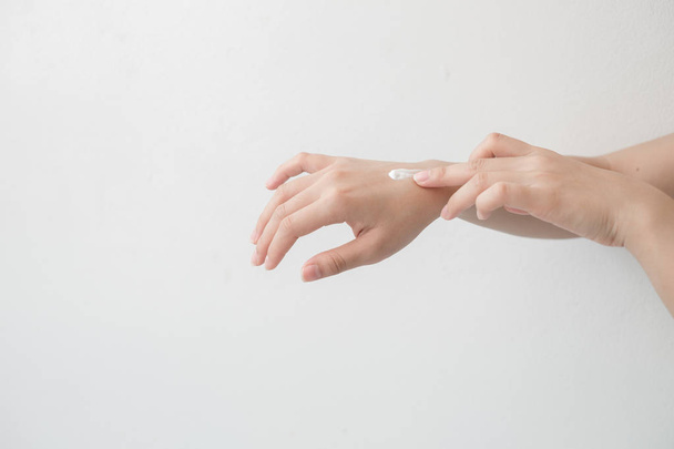 Closeup of beautiful female hands holding hands and applying a moisturizer. Beauty woman's hand applying cream. - Valokuva, kuva